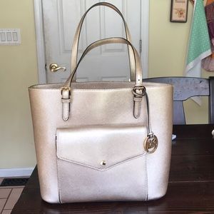 Medium size shiny gold/cream Michael Kohrs purse